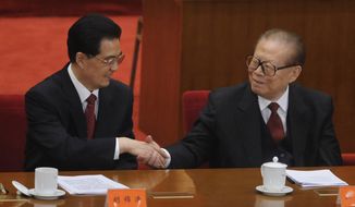 Chinese President Hu Jintao (left) shakes hands with former President Jiang Zemin at the Great Hall of the People in Beijing on Sunday, Oct. 9, 2011, after Mr. Hu delivered a speech at a conference to commemorate the centennial of the 1911 revolution that overthrew imperial rule on the mainland. (AP Photo/Minoru Iwasaki, Pool)