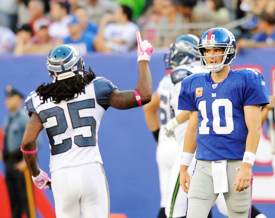 Seattle defensive back Richard Sherman (25) reacts as an interception thrown by Giants quarterback Eli Manning (10) was returned for a touchdown in the Seahawks' 36-25 win Sunday. (Associated Press)