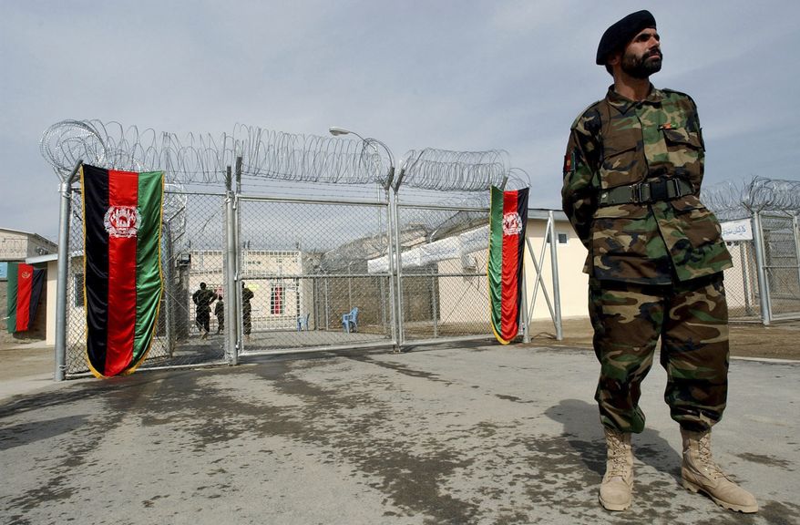** FILE ** An Afghan National Army soldier stands in front of the gate of the newly refurbished Pul-e-Charkhy prison during an opening ceremony in Kabul, Afghanistan, in March 2007. (AP Photo/Musadeq Sadeq, File)