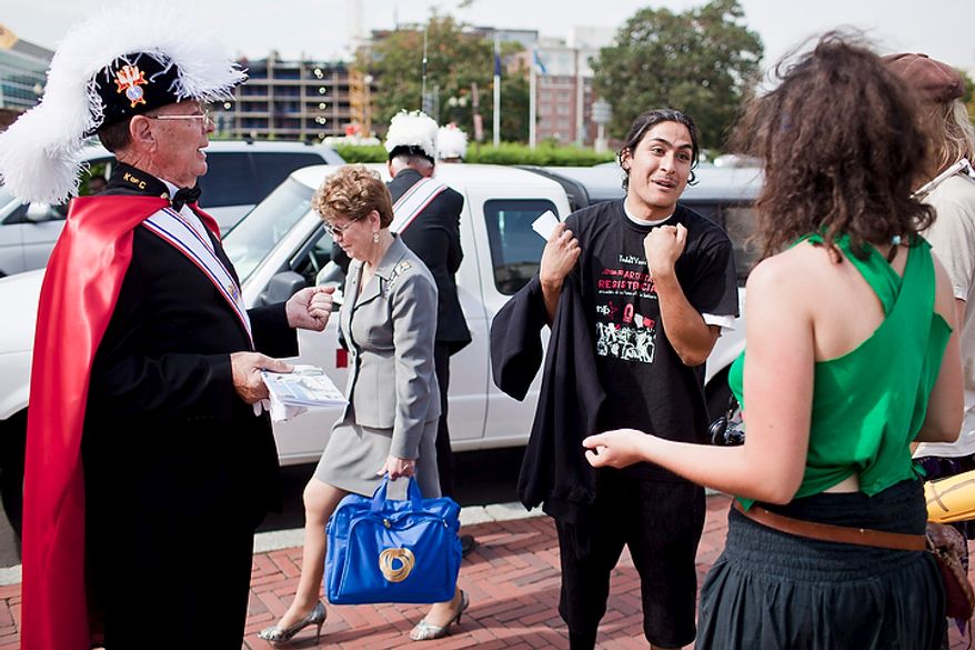 Protesters talk with a Knights of Columbus member following a Columbus Day celebration and wreath presentation at Union Station in Washington on Monday, Oct. 10, 2011. (T.J. Kirkpatrick/The Washington Times)