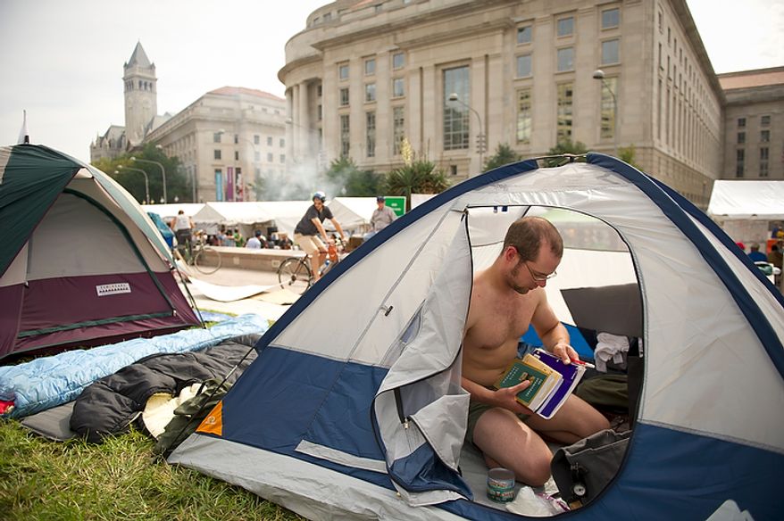 Jacob Griesmer of Mosinee, Wisc., organizes his things inside his tent during a protest affiliated with the "Occupy D.C." movement at Freedom Plaza in Washington, D.C., Monday, October 10, 2011. Mr. Griesmer made the trip from Wisconsin to join the protest. (Rod Lamkey Jr/The Washington Times)