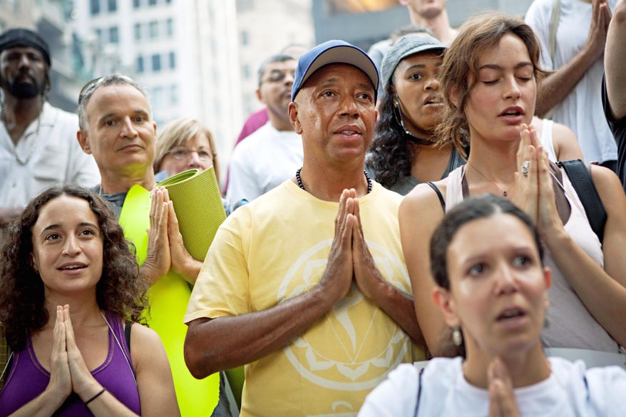 Russell Simmons (center), co-founder of Def Jam records, participates in a yoga session in collaboration with the "Occupy Wall Street" protests in New York's Zuccotti Park. (Associated Press)