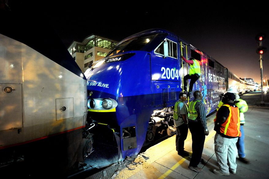 Two Amtrak locomotives rest against each other after colliding at an Oakland, Calif., station on Wednesday, Oct. 12, 2011. (AP Photo/Noah Berger)
