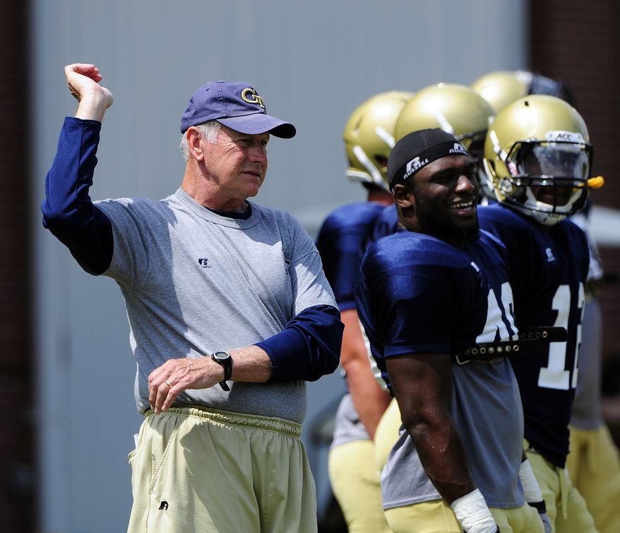 Georgia Tech defensive coordinator Al Groh stretches with members of the Yellow Jackets defense during NCAA college football practice in Atlanta. The former Virginia coach was a polarizing figure during his nine seasons trying to lead his alma mater back to football prominence, and the reception he gets when he returns as the defensive coordinator for No. 12 Georgia Tech on Saturday figures to be mixed, at best. (AP Photo/David Tulis, File)