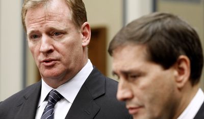 NFL football Commissioner Roger Goodell, left, accompanied by NFL lead counsel Jeff Pash speaks with reporters on Capitol Hill in Washington, Friday, Oct. 14, 2011, after meeting with Rep. Darrell Issa, R-Calif., and Rep. Elijah Cummings, D-Md. to discuss HGH testing for NFL players. (AP Photo/Haraz N. Ghanbari)