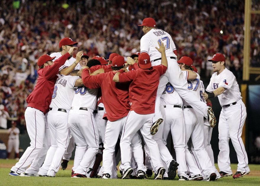 The Texas Rangers&#x27; Nelson Cruz jumps on the crowd after winning baseball&#x27;s American League championship series 15-5 at Game 6 against the Detroit Tigers, Saturday, Oct. 15, 2011, in Arlington, Texas. (AP Photo/Charlie Riedel)