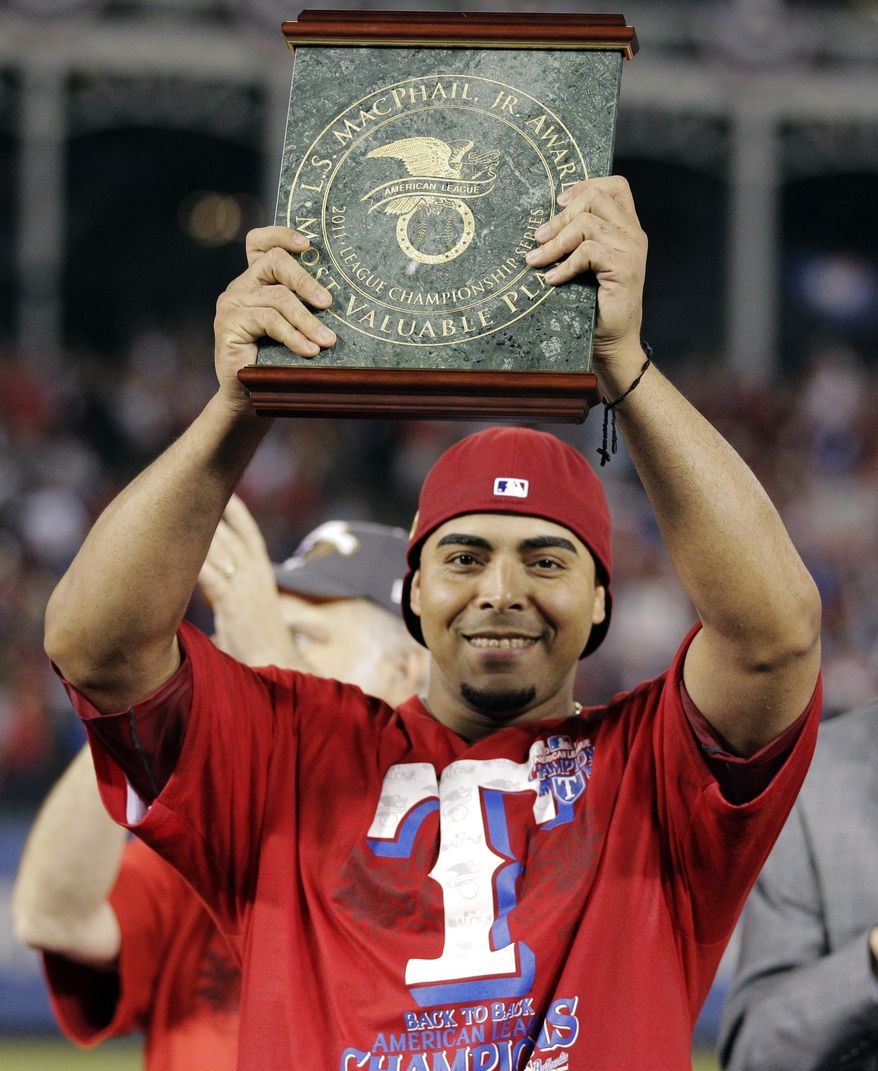 The Texas Rangers&#x27; Nelson Cruz holds the ALCS MVP trophy after hitting six home runs and driving in 13 runs (AP Photo/Charlie Riedel)