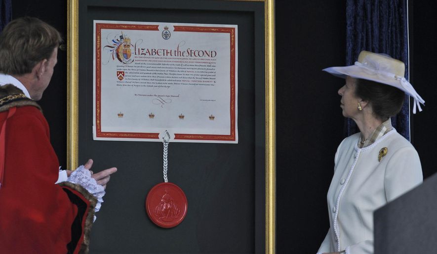 Britain's Princess Anne (right), with Councillor Paul Heaphy, mayor of the town of Royal Wootton Bassett, unveils the Letters Patent granting the English town royal status on Sunday, Oct. 16, 2011. (AP Photo/Ben Birchall/PA Wire)