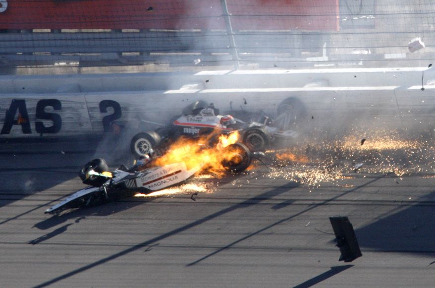 Dan Wheldon, front left, and another driver crash during a wreck that involved 15 cars during the IndyCar Series' Las Vegas Indy 300 auto race at Las Vegas Motor Speedway in Las Vegas on Sunday, Oct. 16, 2011. Wheldon died after the crash. (AP Photo/Las Vegas Review-Journal, Jessica Ebelhar)