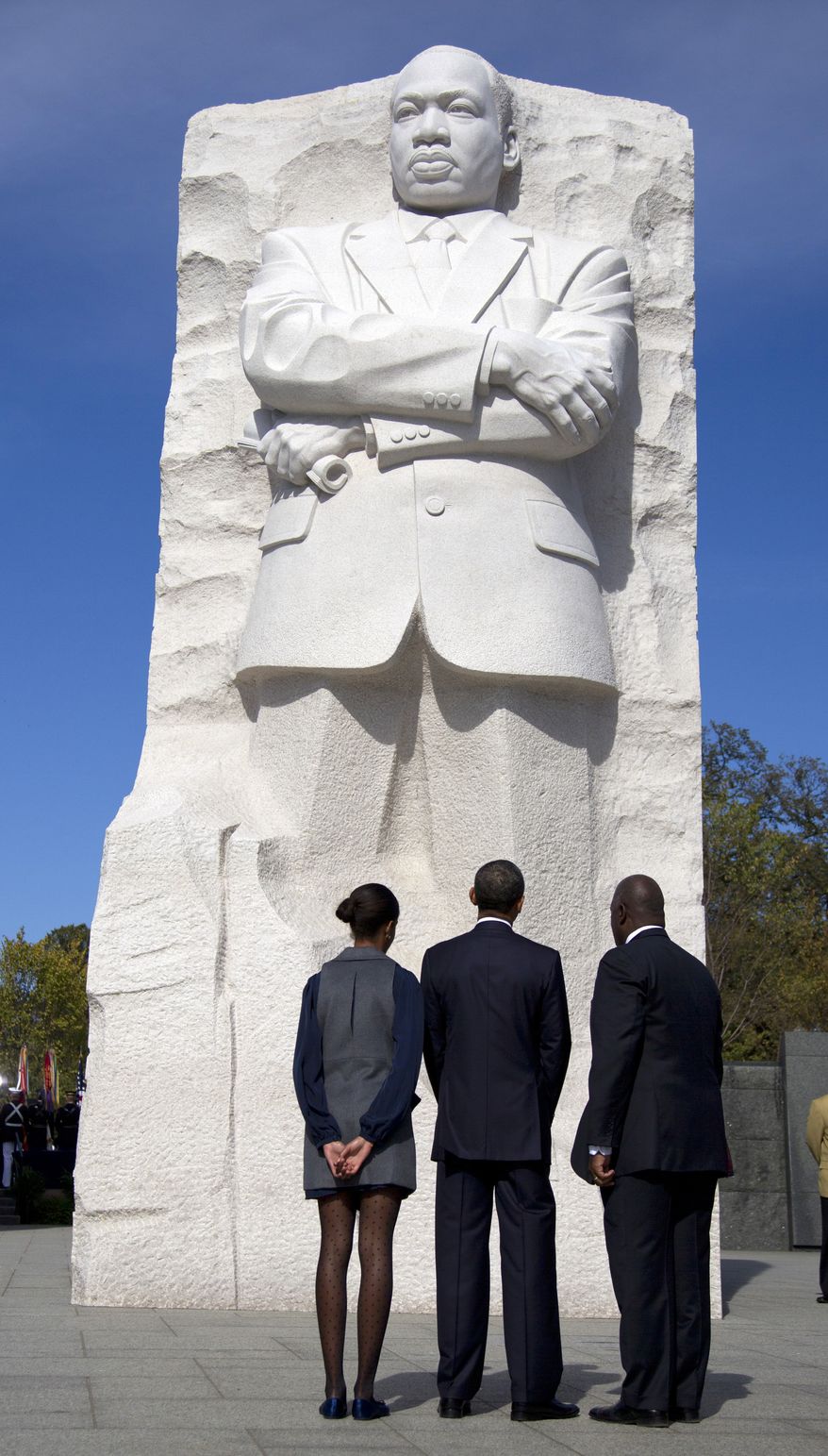 President Obama (center), his daughter Malia (left) and Harry Johnson, president and CEO of the Martin Luther King Jr. Memorial Foundation, look up at the Martin Luther King Jr. Memorial on Sunday, Oct. 16, 2011, on the National Mall in Washington. (AP Photo/Carolyn Kaster)