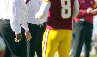 Washington Redskins head coach Mike Shanahan looks at quarterback Rex Grossman (8) leaving the field after throwing an interception to the Philadelphia Eagles during the second quarter. (Andrew Harnik / The Washington Times)
