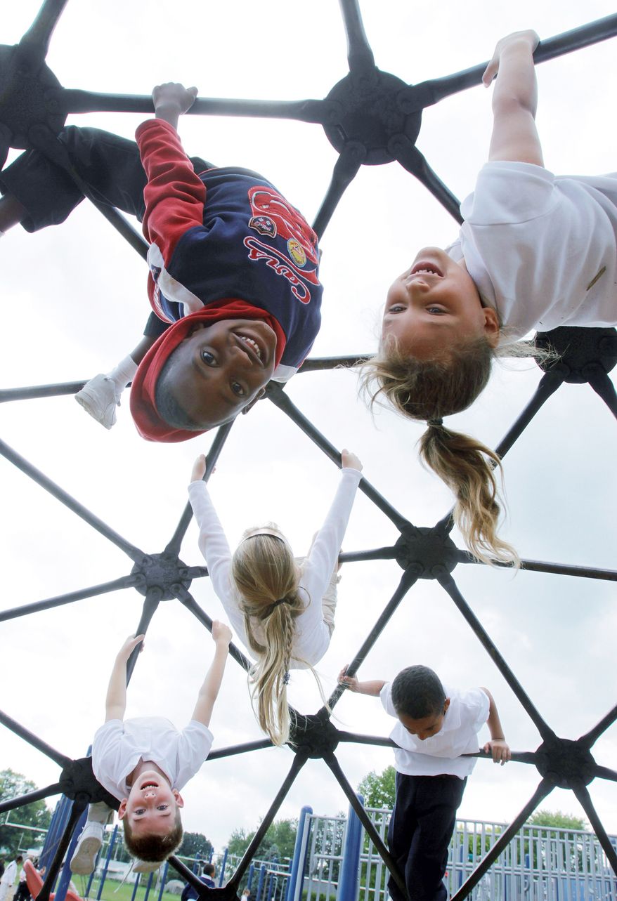 ** FILE ** Students at Northeast Elementary Magnet School in Danville, Ill., enjoy the playground during a physical education class. (Associated Press)
