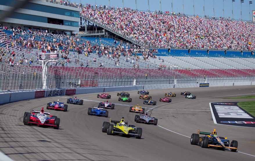 Drivers took five tribute laps in honor of Dan Wheldon, who died following a 15-car crash in the Las Vegas Indy 300 earlier Sunday. The race, the season finale on the IndyCar circuit, did not resume. (Associated Press)