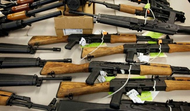 Seized weapons are displayed at a news conference in Phoenix in January. Weapons like these, which were walked into Mexico, are at the heart of the Fast and Furious investigation under way on Capitol Hill. (Associated Press)