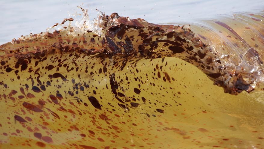**FILE** Crude oil from the Deepwater Horizon oil spill washes ashore in Orange Beach, Ala., on June 12, 2010. (Associated Press)