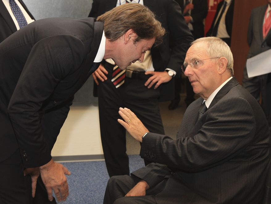 **FILE** French Finance Minister Francois Baroin (left) talks with German Finance Minister Wolfgang Schaeuble during the Eurogroup ministers meeting in Luxembourg on Oct. 3, 2011. (Associated Press)
