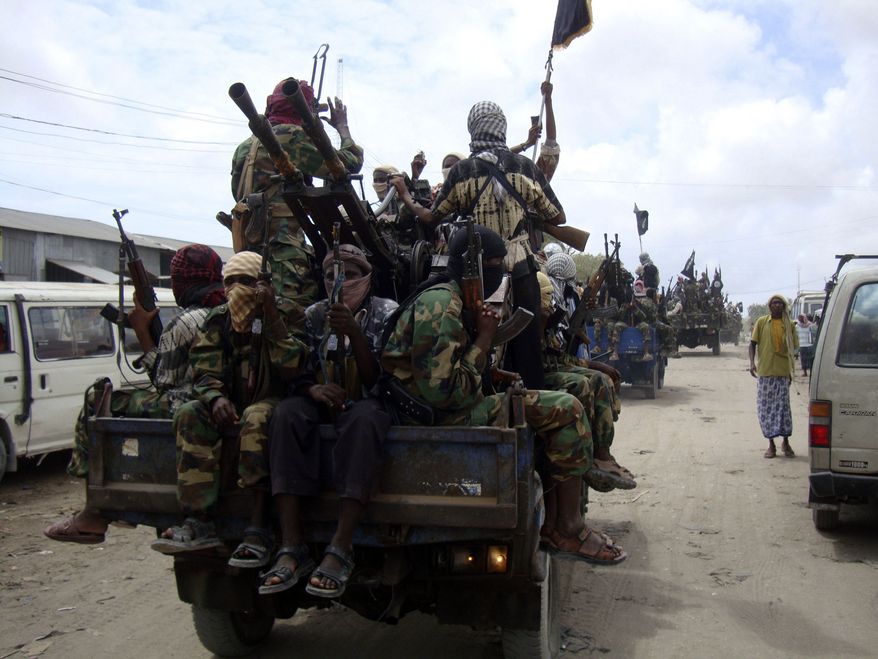 **FILE** Al-Shabab fighters display weapons as they conduct military exercises Oct. 21, 2010, in northern Mogadishu, Somalia. (Associated Press)