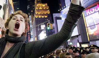 Occupy Wall Street protester Ashlie Lauren Smith, a music student from Cincinnati, screams about the $90,000 she owes in student loans at a Times Square rally on Saturday. The protests in New York and other cities have been a source of new material for comedians and satirists. (Associated Press)