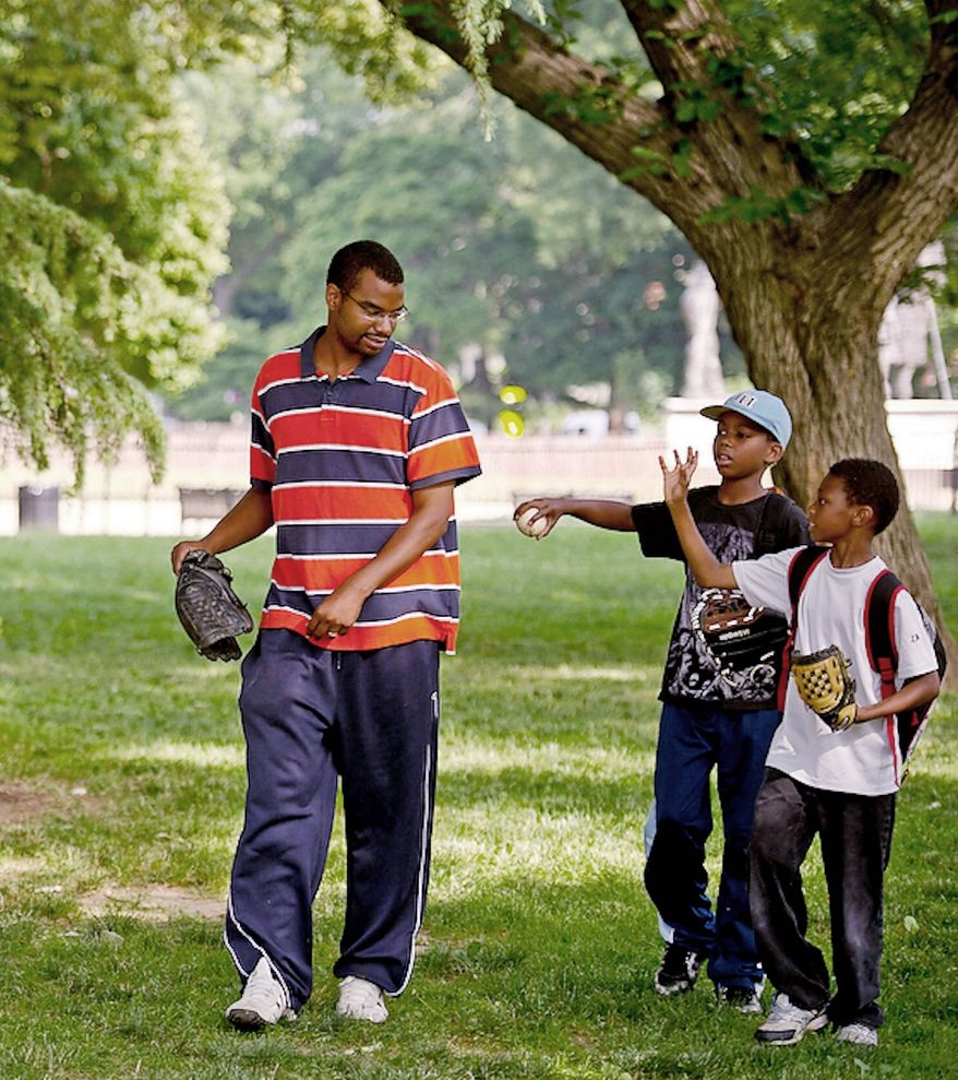 Akinlabi Mason plays catch with his two sons Elijah, 8, (right) and Paul, 9, (center) at Lincoln Park in Washington, D.C., Tuesday, June 7, 2011, before taking them off to school. Mr. Mason spends quality time with his two boys, helping to teach them the fundamentals of baseball as he shepherds them through a season of Little League and beyond. In recent years the sport of baseball is experiencing a big decline of African Americans in the game. (Rod Lamkey Jr./The Washington Times)