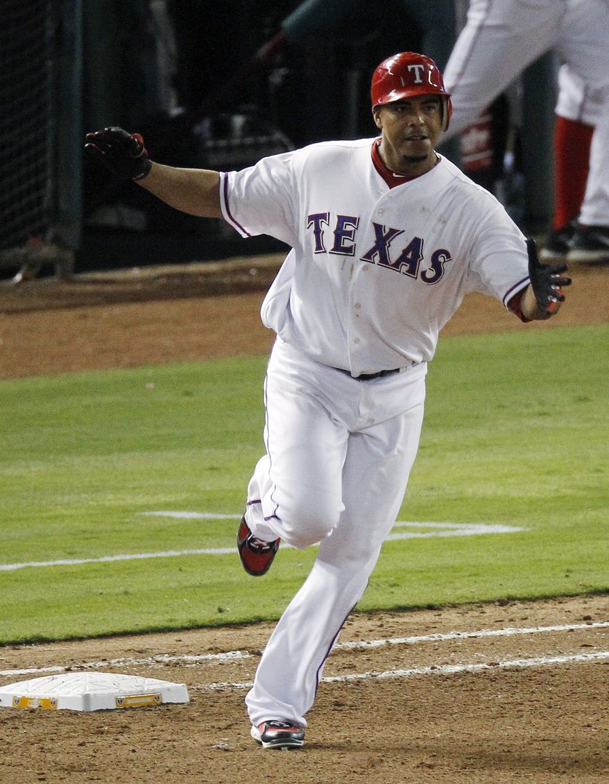 Texas Rangers&#x27; Nelson Cruz rounds the bases after hitting a two-run home run against the Detroit Tigers during the seventh inning at Game 6 of the American League Championship Series on Saturday, Oct. 15, 2011, in Arlington, Texas. (AP Photo/Eric Gay)