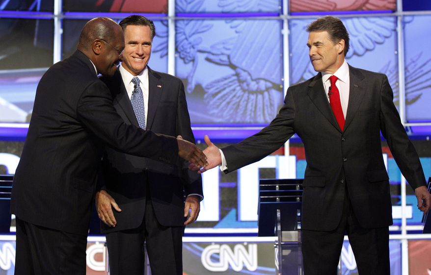Republican presidential candidates Herman Cain, left, shakes hands with Texas Gov. Rick Perry, right, as former Massachusetts Gov. Mitt Romney looks on before a Republican presidential debate Tuesday, Oct. 18, 2011, in Las Vegas. (AP Photo/Isaac Brekken)