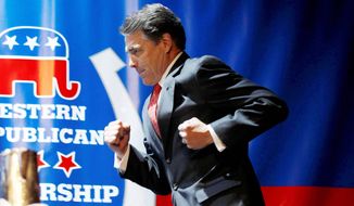 Texas Gov. Rick Perry runs to deliver a keynote address during the Western Republican Leadership Conference in Las Vegas on Wednesday. (Associated Press)