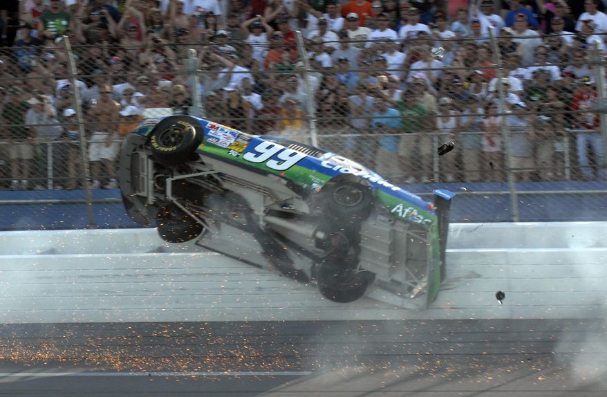 This April 26, 2009, file photo shows Carl Edwards hitting the fence during a crash on the last lap of the Aaron's 499 NASCAR Sprint Cup Series race at Talladega Superspeedway, in Talladega, Ala. The death of Indianapolis 500 winner Dan Wheldon has sparked safety discussions throughout motorsports just as NASCAR heads to one of the fastest tracks on its circuit. (AP Photo/Rainier Ehrhardt)