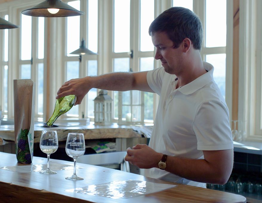 Brooks Tate at Pippin Hill Farm in North Garden, Va., pours a glass of white wine made from grapes borrowed from other vineyards. (Steve Hay/Special to The Washington Times)