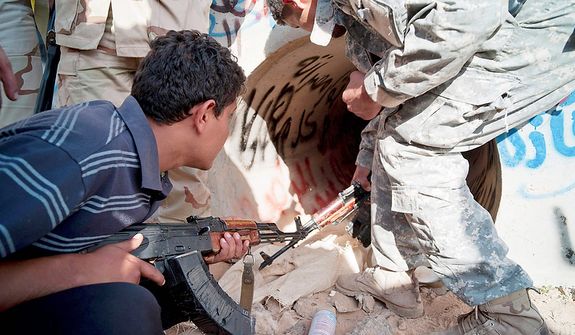 Revolutionary Libyan fighters inspect the tunnels in which Col. Moammar Gadhafi is claimed to have been found in Sirte, Libya, on Oct. 20, 2011. (Associated Press)