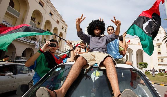 Libyans celebrate Col. Moammar Gadhafi&#39;s death in Tripoli, Libya, on Oct. 20, 2011. (Associated Press)