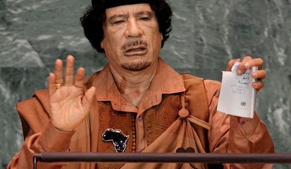 In this photo from Sept. 23, 2009, Libyan leader Col. Moammar Gadhafi shows a torn copy of the United Nations Charter during his address to the 64th session of the U.N. General Assembly. (Associated Press)