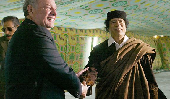 In this photo from Dec. 19, 2004, Canada Prime Minister Paul Martin shakes hands with Libyan leader Col. Moammar Gadhafi at his military compound in a tent in Tripoli, Libya. (Associated Press/The Canadian Press)