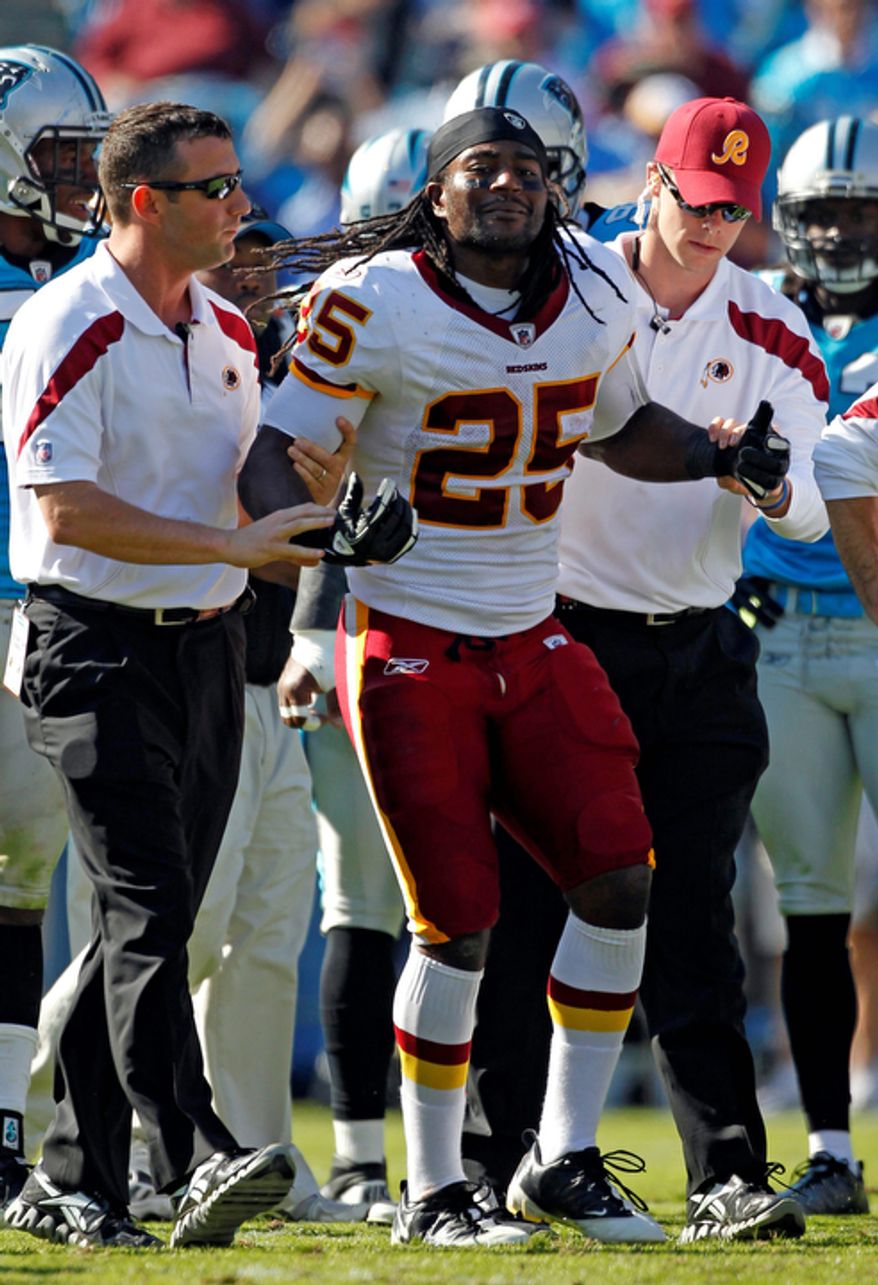 Washington Redskins' Tim Hightower (25) is helped from the field after being injured during the third quarter of against the Carolina Panthers in Charlotte, N.C., Sunday, Oct. 23, 2011. Hightower ended up tearing his ACL. (AP Photo/Bob Leverone)