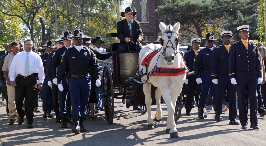 Members of the Birmingham Police Department and Birmingham Fire and Rescue escort the casket of the Rev. Fred L. Shuttlesworth from Bethel Baptist Church to the new Bethel Baptist Church in the Collegeville neighborhood of Birmingham, Ala., on Saturday, Oct. 22, 2011. (AP Photo/The Birmingham News, Michelle Campbell)