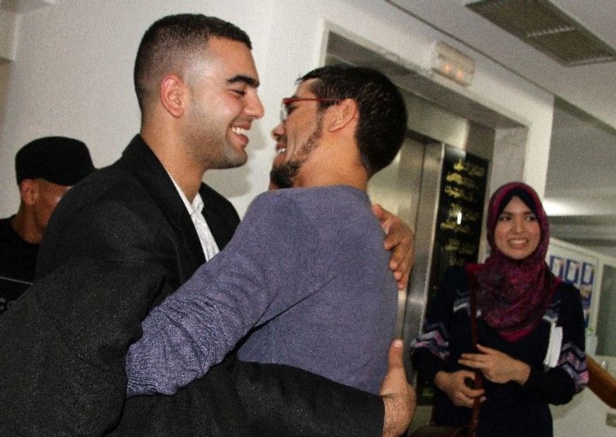 Supporters of the Islamist Ennahda party celebrate after early signs showed that the party was ahead in national voting. (Associated Press)