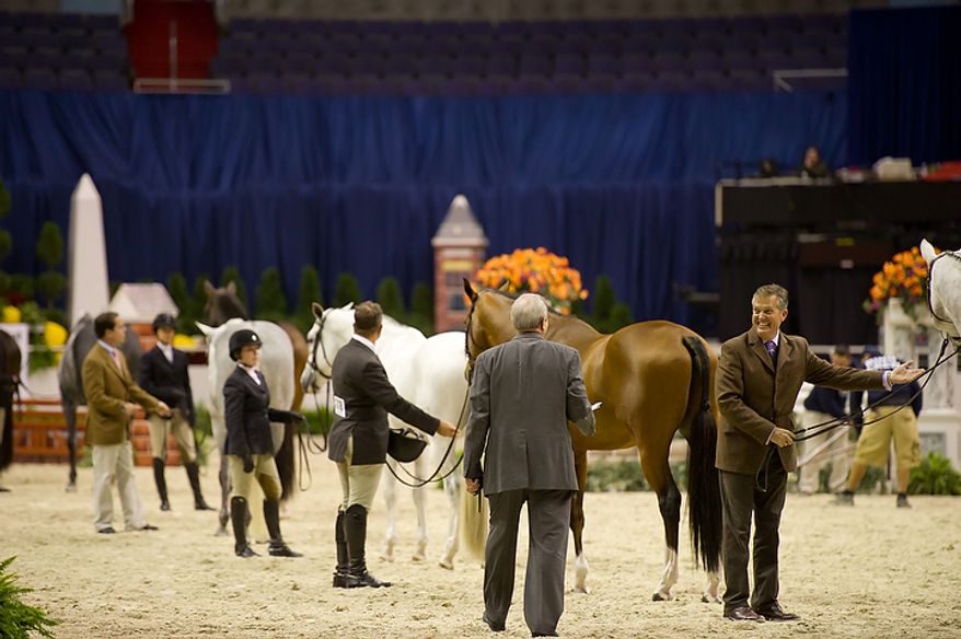 Bill Schaub (right) shows off his horse "Photo Shoot" at the annual Washington International Horse Show on Oct. 25, 2011, in D.C. The event runs Oct. 25-30 at the Verizon Center and features top riders and horses competing from the U.S. and abroad. (Andrew Harnik/The Washington Times)