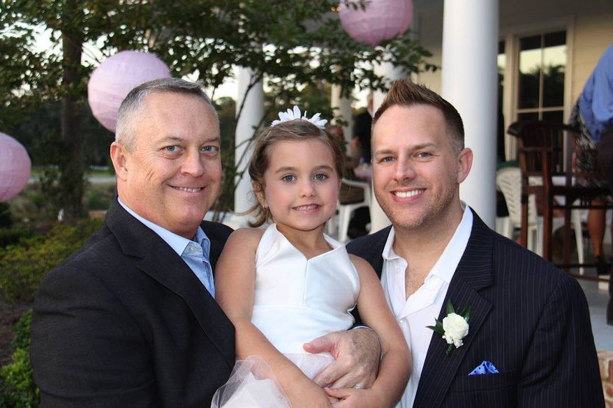 Jeff Littlefield (left) and his husband Tommy Starling attend a friend's wedding in Pawley's Iland, S.C. with their 5-year-old daughter, Carrigan Starling-Littlefield. The two men became parents through a surrogacy program in California and later got married during a brief period when same-sex marriage was legal in California. (Associated Press)