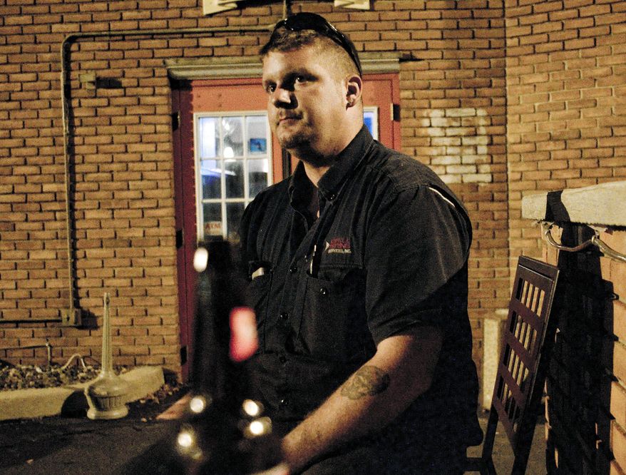 Jordon Bourque, 23, a pipe inspector from Lafayette, La., has a beer at a bar in Williamsport, Pa., where he works on the Marcellus Shale. The gas boom has brought a wave of hardworking, sometimes raucous workers to small towns. (Associated Press)