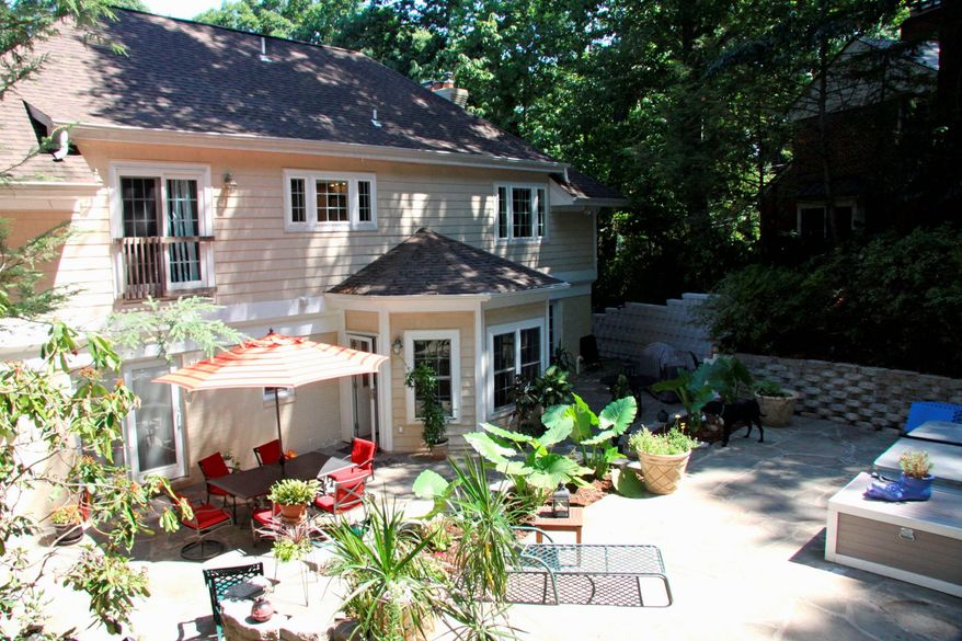 The owners of the home at 4424 25th St. N. in Arlington's Lee Heights neighborhood worked with a landscape architect to create stone terraces and walls and garden beds out of the hilly backyard.