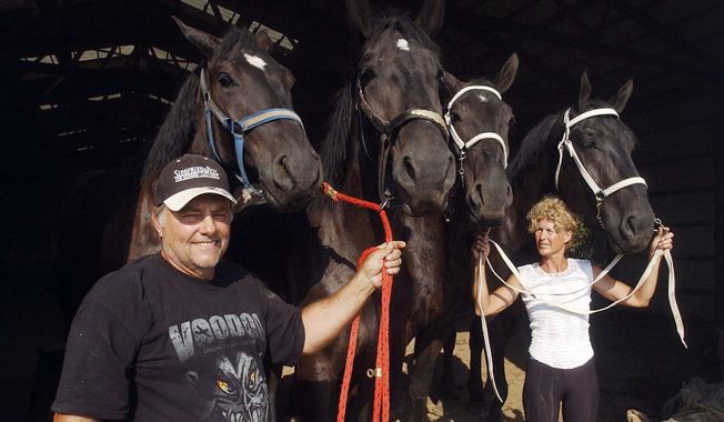 Terry Thompson and his wife, Marian, lead horses on their farm west of Zanesville, Ohio, in August 2008. She is trying to reclaim three leopards, two primates and a young grizzly from the Columbus Zoo, which has held them since her husband opened the cages of 56 exotic animals before killing himself Oct. 18. (Associated Press)