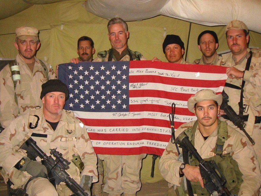 The special operations team Col. Bowers personally selected all signed a flag, which he carried on the mission, along with a piece of World Trade Center steel. (Army Special Operations Command)