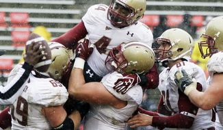 Boston College running back Andre Williams, top center, celebrates with his teammates after scoring a touchdown in the first half against Maryland in College Park, Md., Saturday, Oct. 29, 2011. (AP Photo/Patrick Semansky)