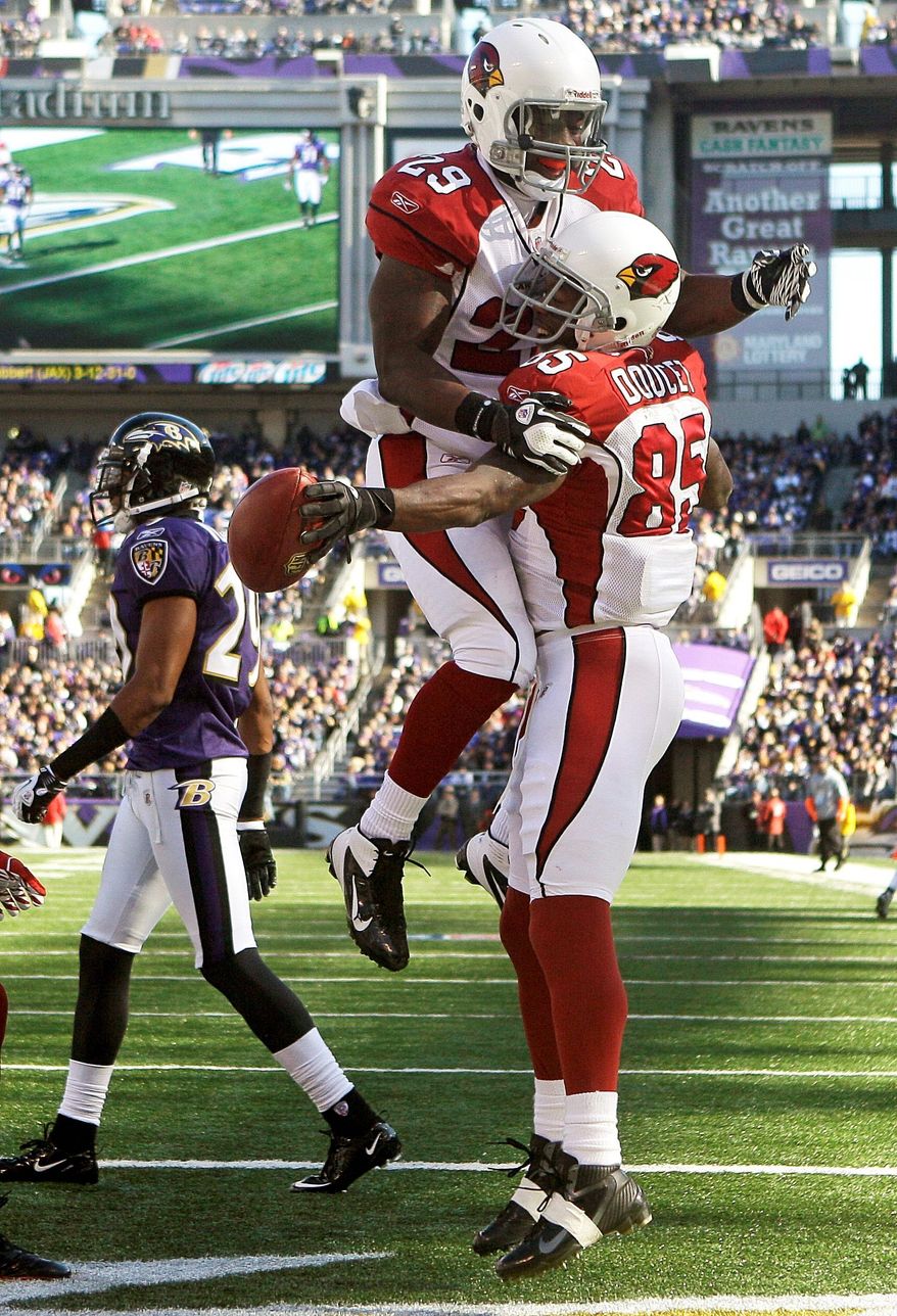 Arizona receiver Early Doucet (right) celebrates with Chester Taylor after scoring a first-half toucndown. The Cardinals have lost six straight . (Associated Press)