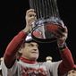 St. Louis Cardinals manager Tony La Russa holds up the Commissioner&#39;s Trophy after Game 7 of the World Series against the Texas Rangers on Friday, Oct. 28, 2011, in St. Louis. The Cardinals won 6-2 to win the series. (AP Photo/Charlie Riedel)