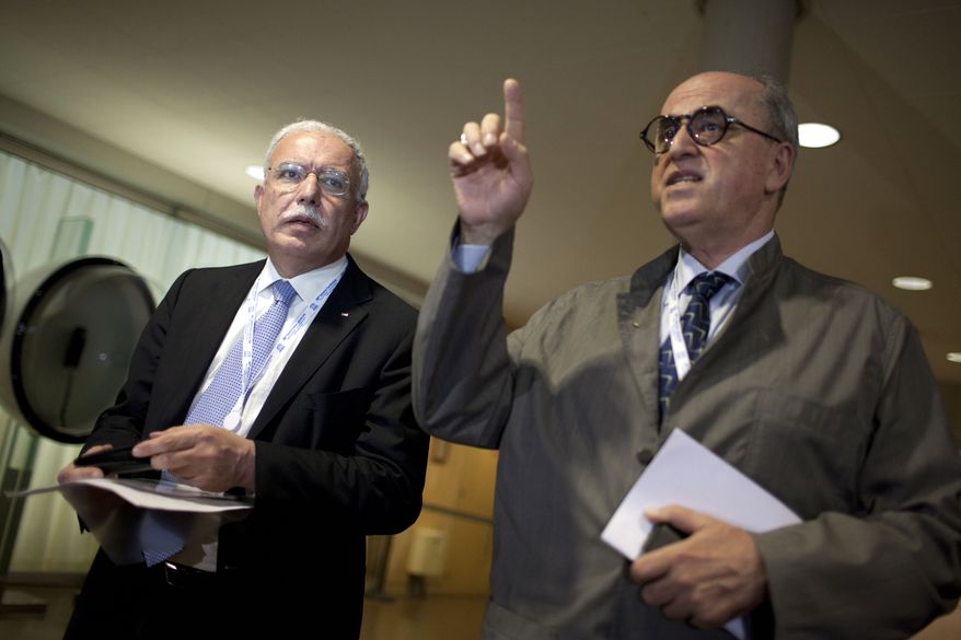 Palestinian Foreign Minister Riad al-Maliki (left) and Elias Sanbar, ambassador for Palestine at UNESCO, attend a session of UNESCO's 36th General Conference in Paris on Monday, Oct. 31, 2011. (AP Photo/Thibault Camus)