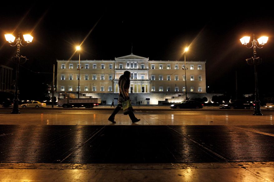 A woman walks outside the Greek parliament in central Athens, on Nov. 1, 2011. Lawmakers in Greece's ruling Socialist party revolted over their prime minister's surprise decision to hold a referendum on a European debt deal, threatening the very survival of his embattled government. (Associated Press)