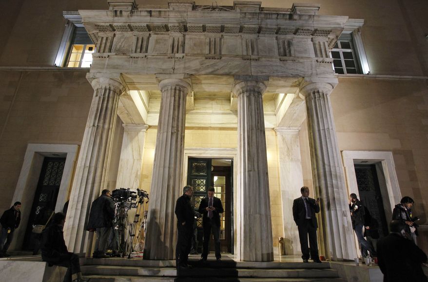 Media gather outside the Greek parliament during a cabinet meeting in Athens on Nov. 1, 2011. Lawmakers in Greece's ruling Socialist party revolted over their prime minister's surprise decision to hold a referendum on a European debt deal, threatening the very survival of his embattled government. (Associated Press)