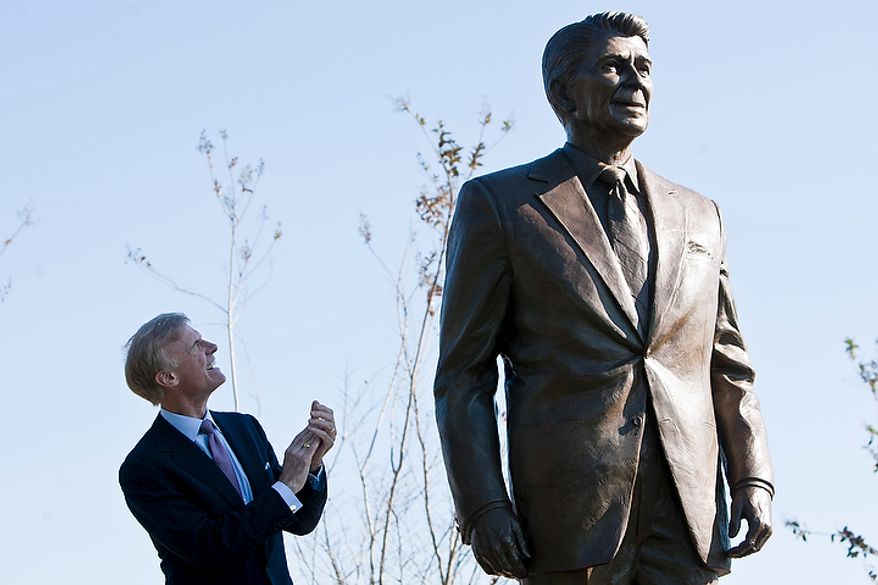 Frederick Ryan Jr., chairman of the board of trustees of the Ronald Reagan Presidential Foundation, unveils a bronze statue of Ronald Reagan at Reagan National Airport in Arlington, Va., on Nov. 1, 2011. The unveiling was part of a dedication ceremony on the centennial of the former president's birth. (T.J. Kirkpatrick/The Washington Times)