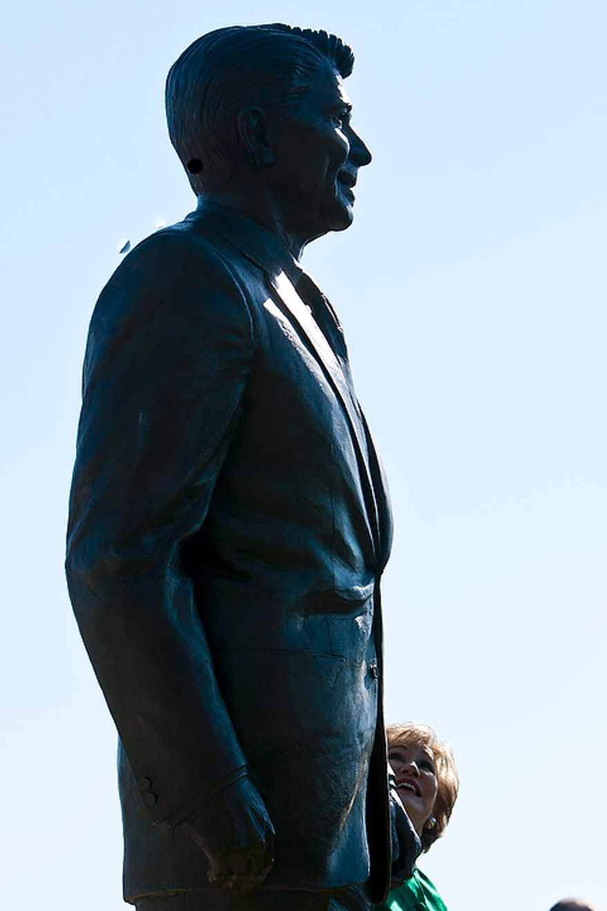 Former Transportation Secretary Elizabeth Dole looks up at a bronze statue of Ronald Reagan at Reagan National Airport in Arlington, Va., on Nov. 1, 2011. The statue was unveiled as part of a dedication ceremony on the centennial of the former president's birth. (T.J. Kirkpatrick/The Washington Times)