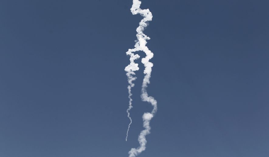 A smoke trail from a missile Israel test-fired Wednesday is seen from Yavne, Israel. The missile reportedly can carry an atomic warhead and hit Iran, and the launch has increased speculation that Israel is planning a pre-emptive strike. (Associated Press)